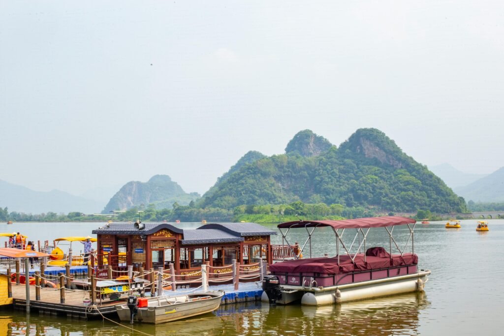 Scenic view of boats docked on the Li River with karst mountains in the background, Guangxi, China.