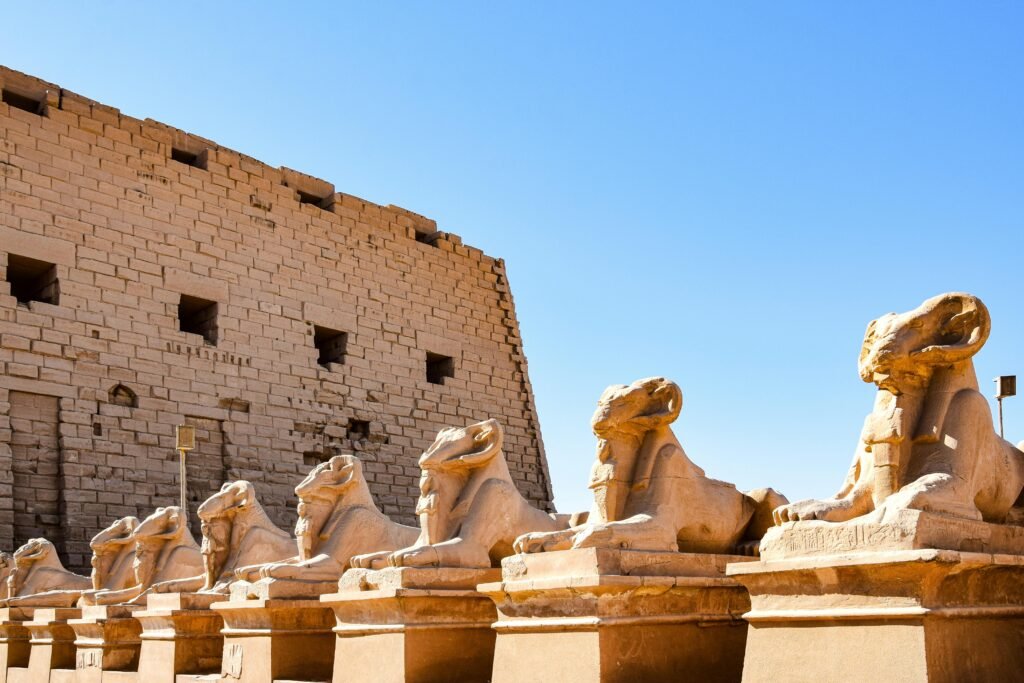 Row of ancient sphinx statues at the historic Karnak Temple Complex in Luxor, Egypt.