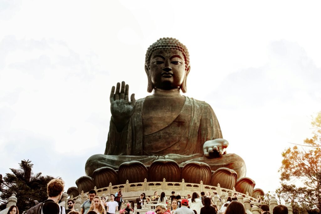 A majestic view of the Tian Tan Buddha statue in Hong Kong with visiting tourists.