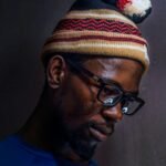 Portrait of a man in glasses and knit cap, deep in thought in Soweto, South Africa.